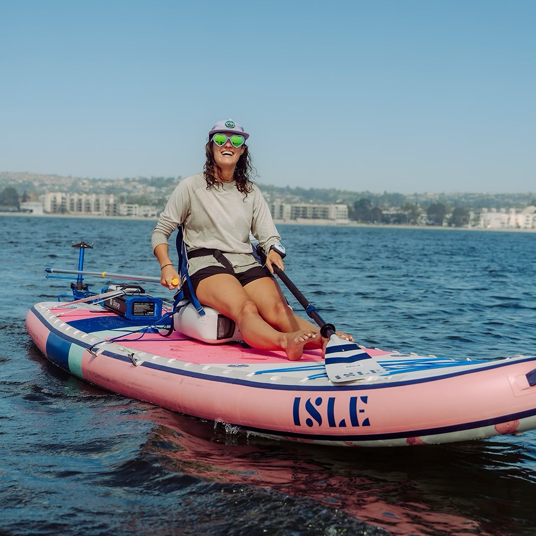 Woman sitting on a paddleboard while using a Bixpy motor