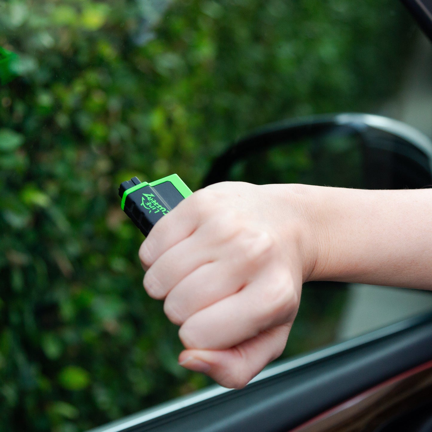 Person holding Line Cutterz "VET" Vehicle Escape Tool in their hand