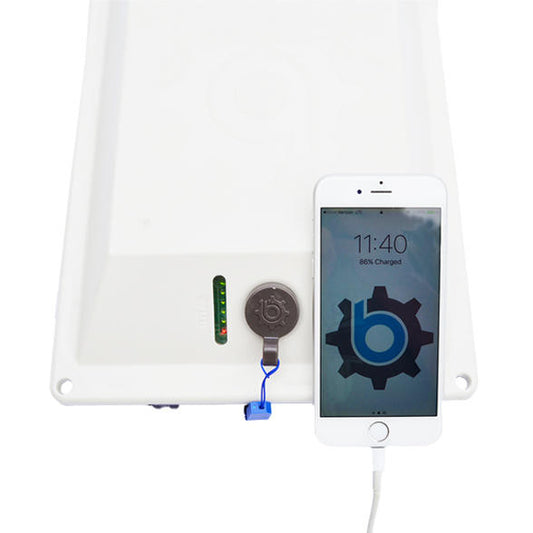 Close-up of a smartphone charging via the Bixpy 5V USB cable connected to a white Bixpy battery pack.