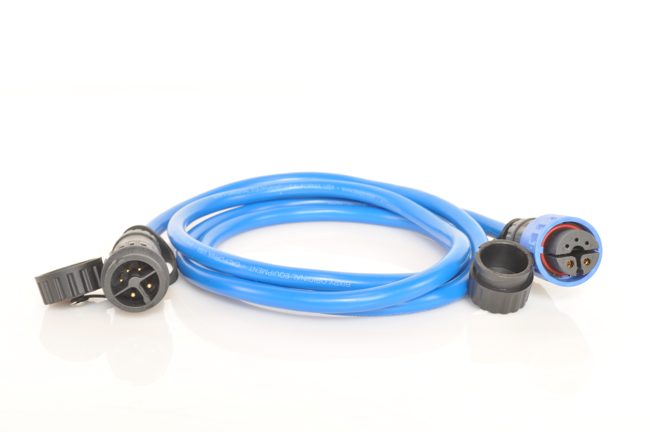 Flat-lay of Bixpy extension cable showing male and female connectors with protective caps.