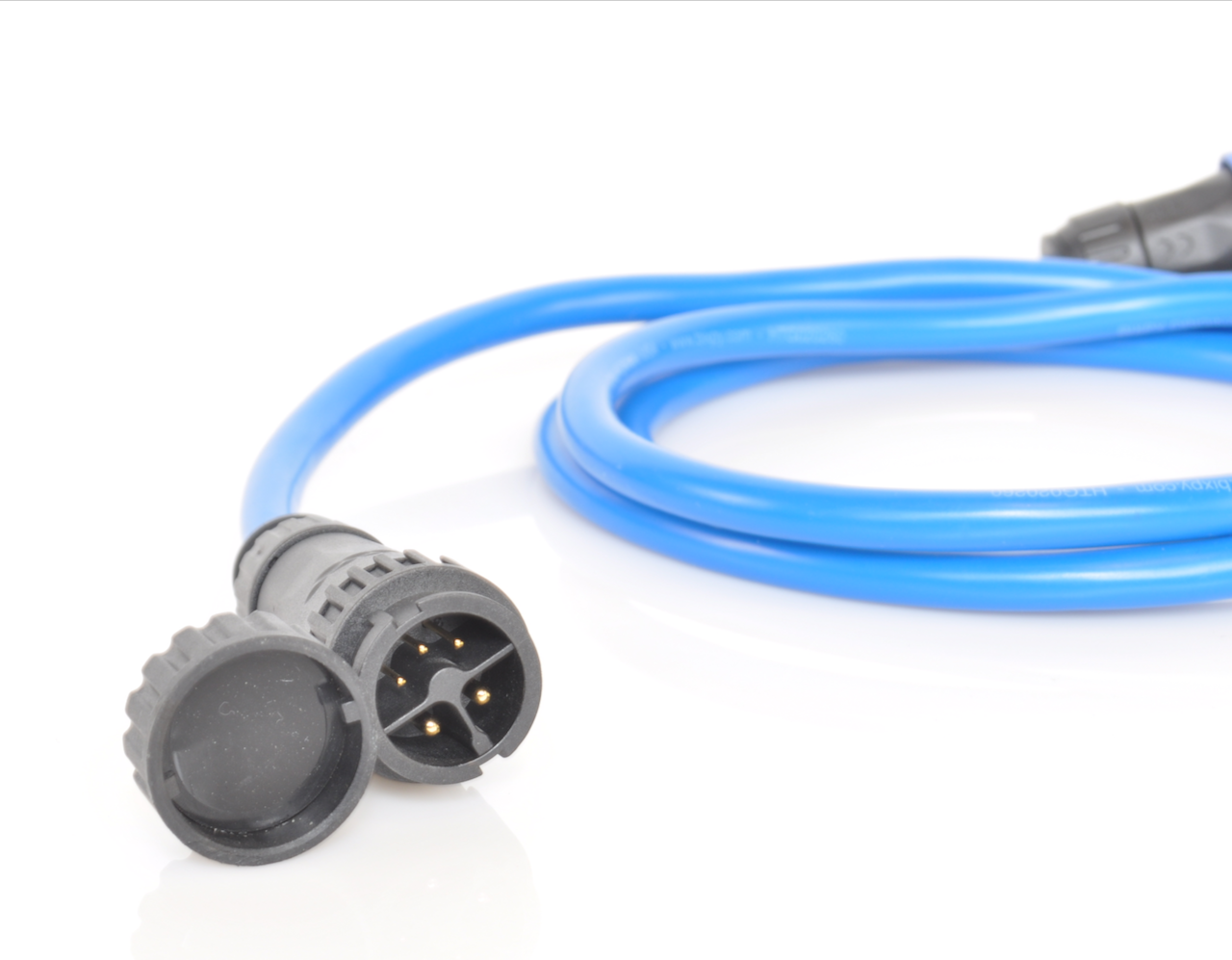 Close-up of waterproof connectors on Bixpy extension cable with cable extending out of frame.