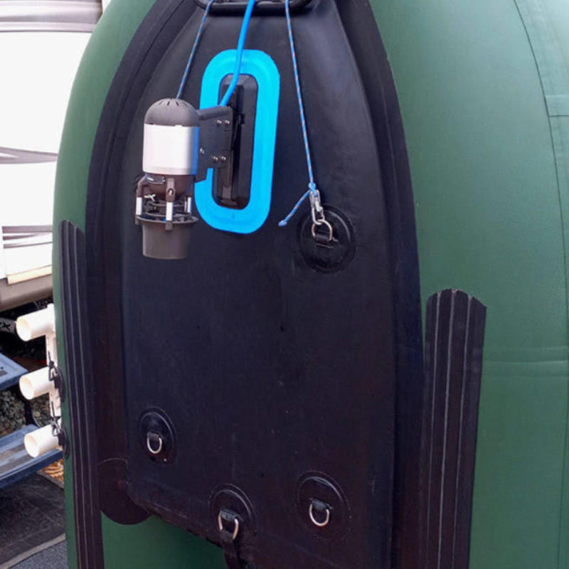 Close-up of a Bixpy Jet electric motor mounted to the black transom of an olive green inflatable boat.
