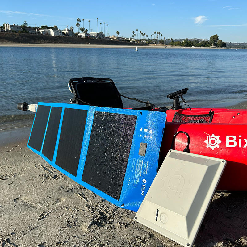 Bixpy Solar Charging Kit on the beach, powering a kayak.
