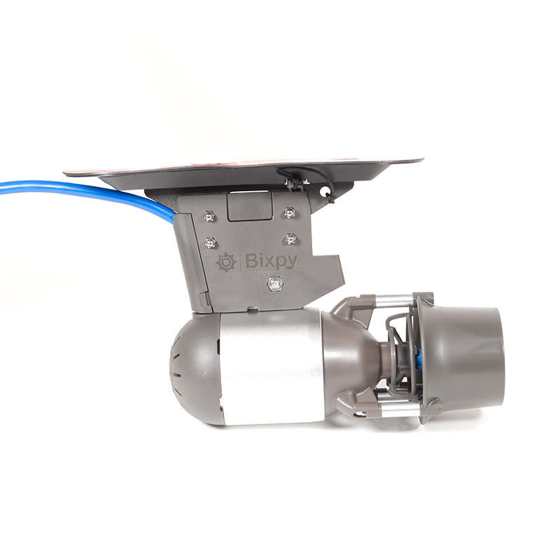 Bixpy Jet electric motor attached to a black mounting adapter with a visible red adhesive backing and blue cable, on a white background.