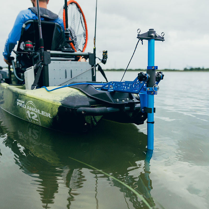 Kayak angler using a Bixpy Jet Motor with a Power-Pole anchor. The Power-Pole is deployed in shallow water.