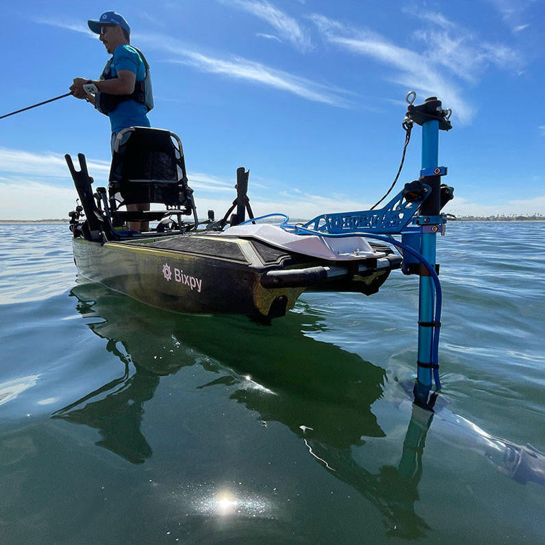 Kayak angler using a Bixpy Jet Motor with a Power-Pole adapter for hands-free fishing.