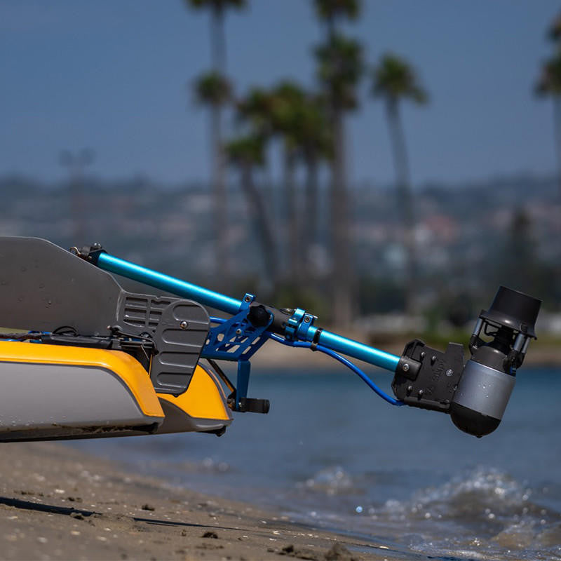Bixpy Jet Motor attached to a yellow and gray kayak on a beach.