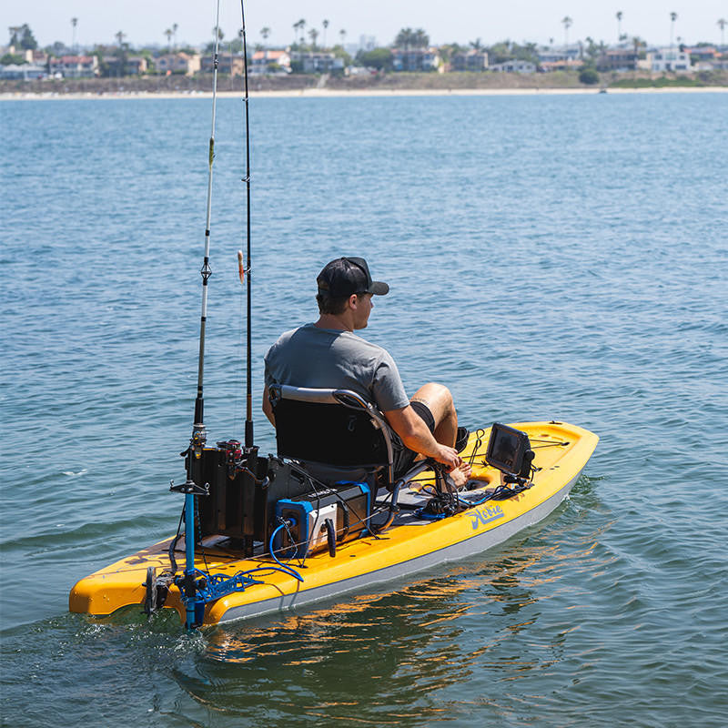 Kayak angler using a Bixpy Jet Motor, battery pack, and fishing rod holders.