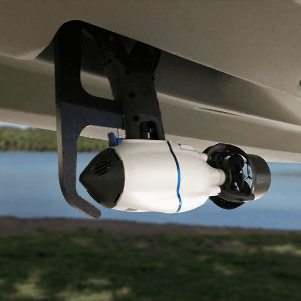 Underside view of Bixpy J-1 Motor mounted to kayak using Bonafide Pod Adapter, showing motor placement and custom bracket installation near water.