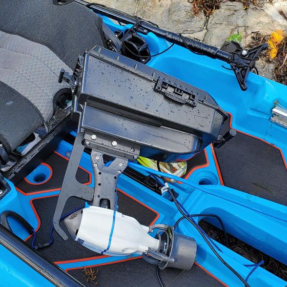 Bonafide Pod Adapter with Bixpy J-1 Motor mounted in blue Bonafide kayak, shown from above with integrated dry pod and waterproof motor cable.