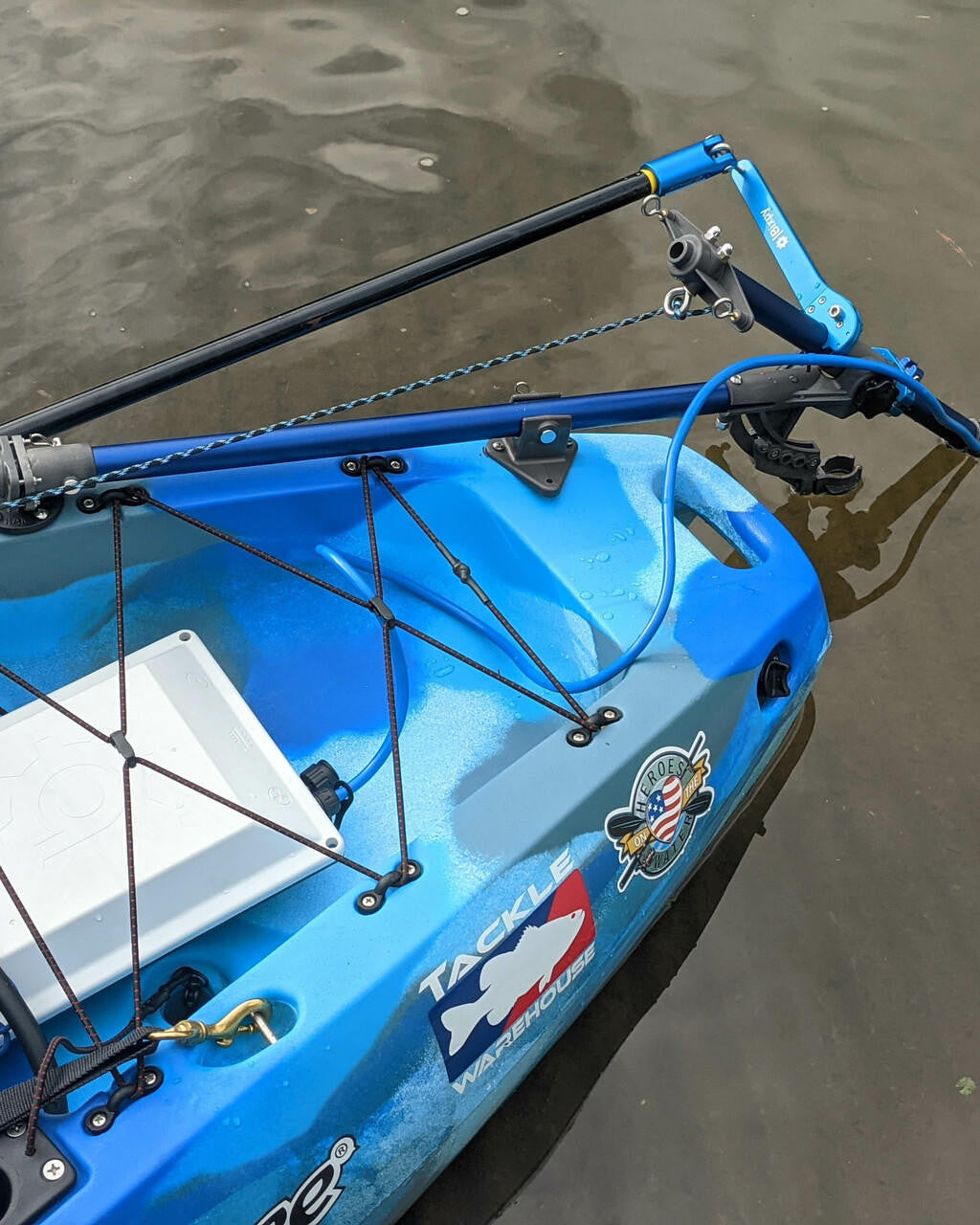 Top view of a blue camouflage kayak featuring a Bixpy Universal Kayak Adapter mounted to its side.