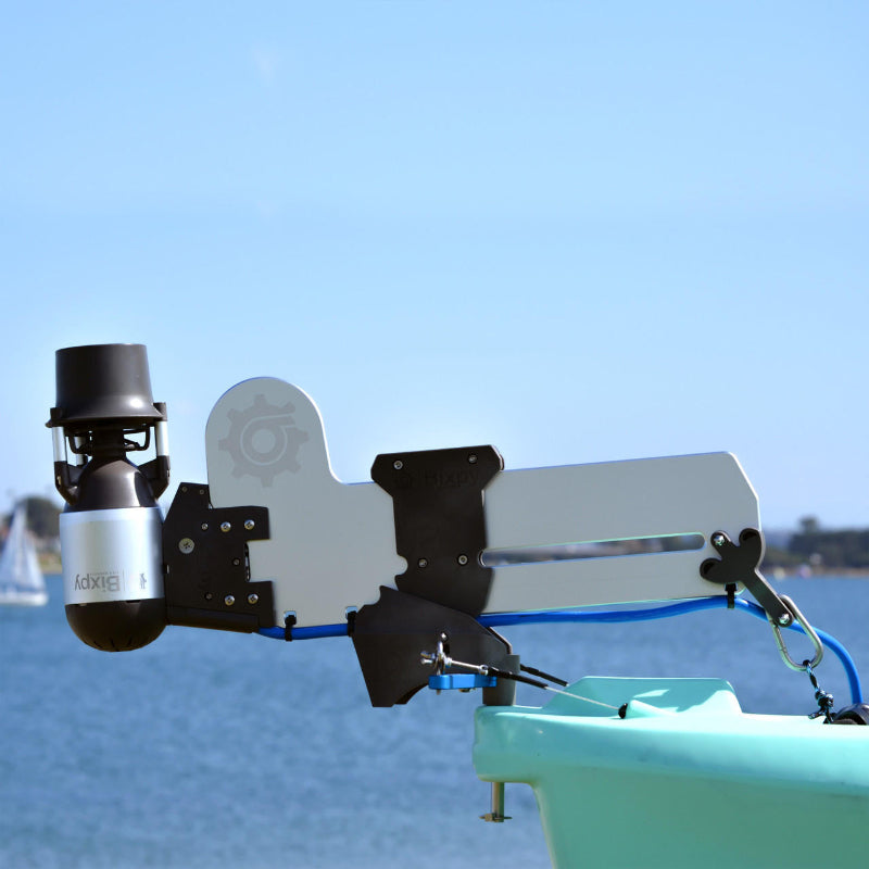 Bixpy Jet electric motor mounted to a light gray rudder adapter on a teal boat.