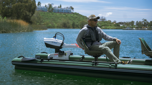 a person on a small boat with bixpy motor on a lake
