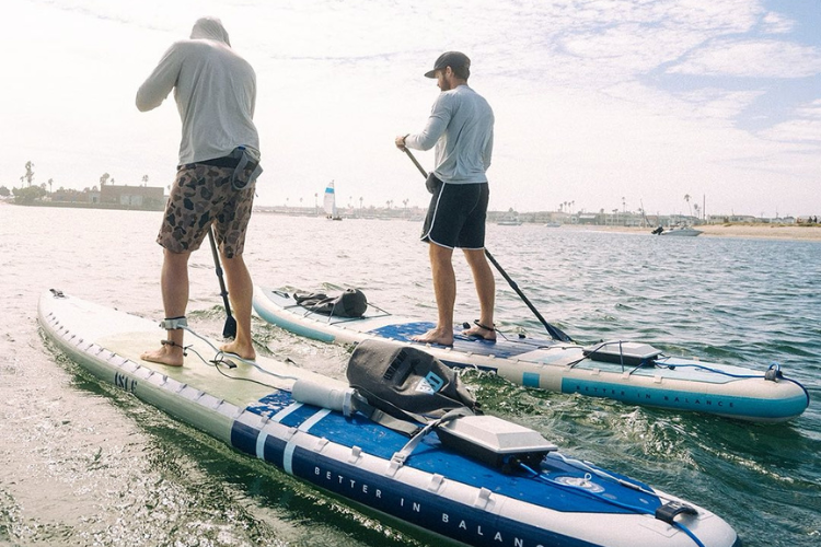 Two men on SUPs using Bixpy motors