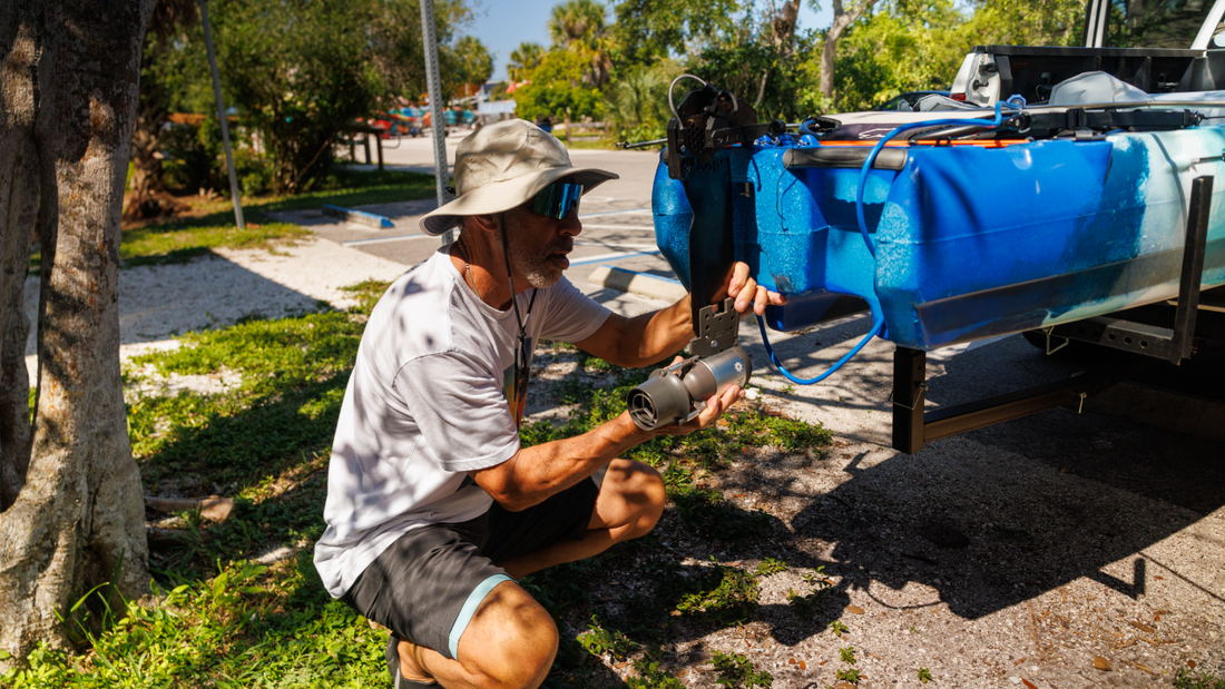 Man fastens Bixpy K-1 to his watercraft