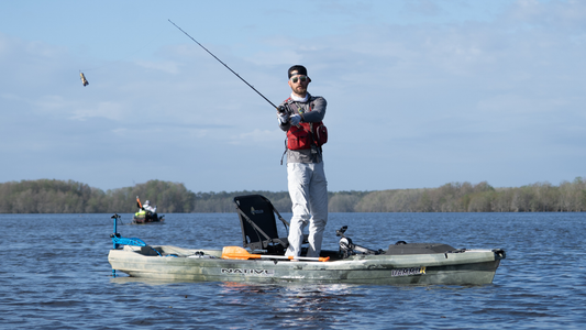 a man fishing on a kayak with bixpy motor on a lake