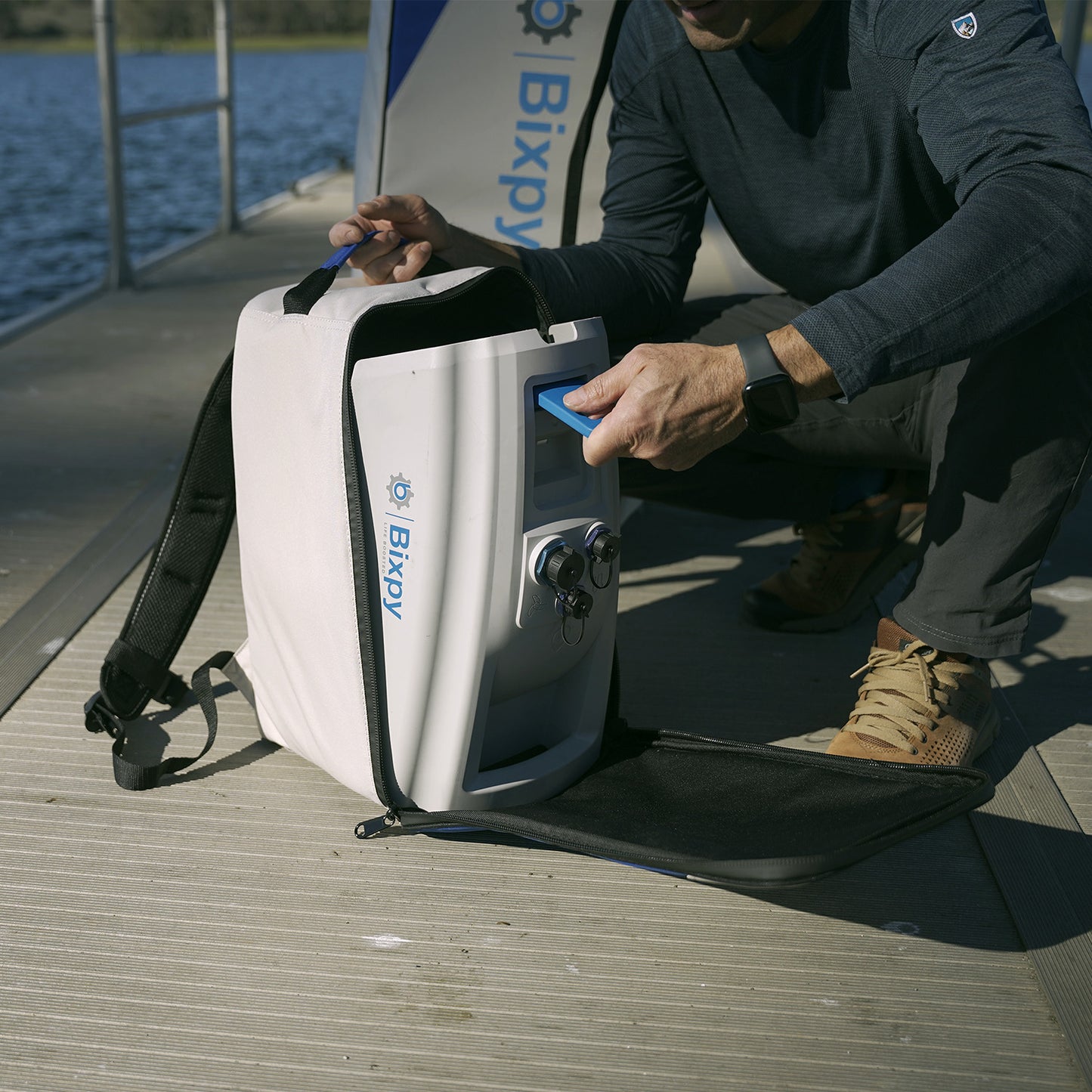 man putting n-3 battery in a backpack