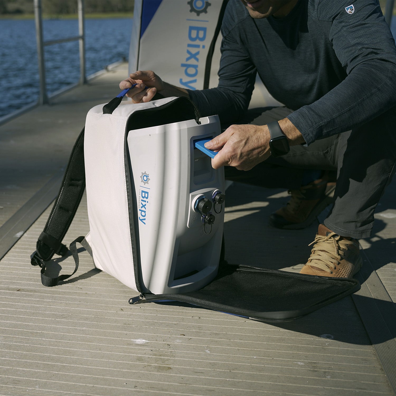 man putting n-3 battery in a backpack