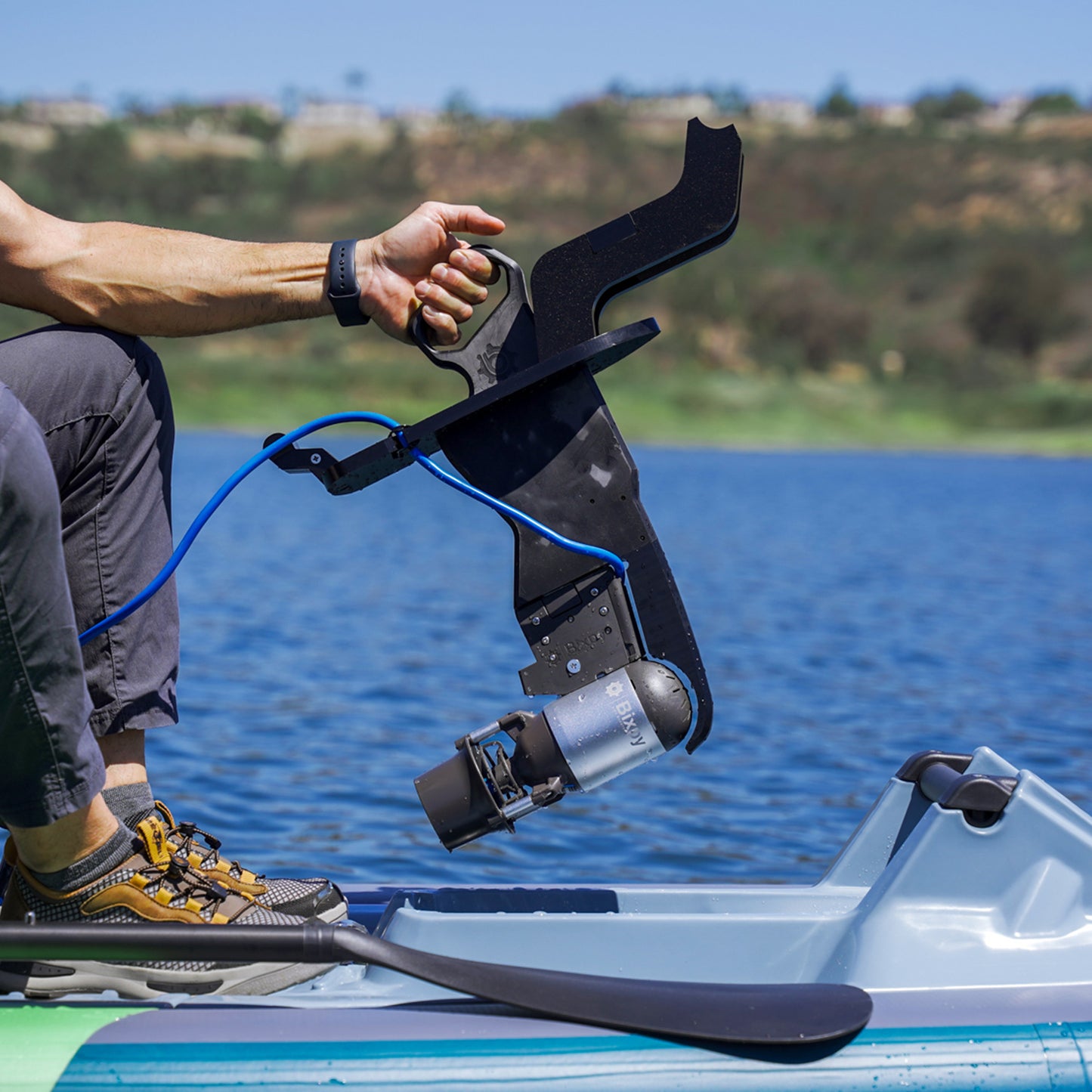 Man inserts Feelfree Profish Pedal Drive Adapter into kayak with K-1 attached