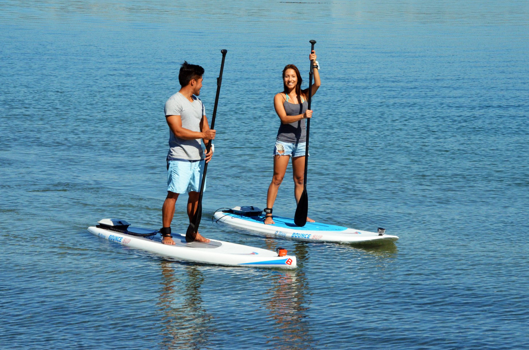 two friends paddleboarding with the help of Bixpy motors