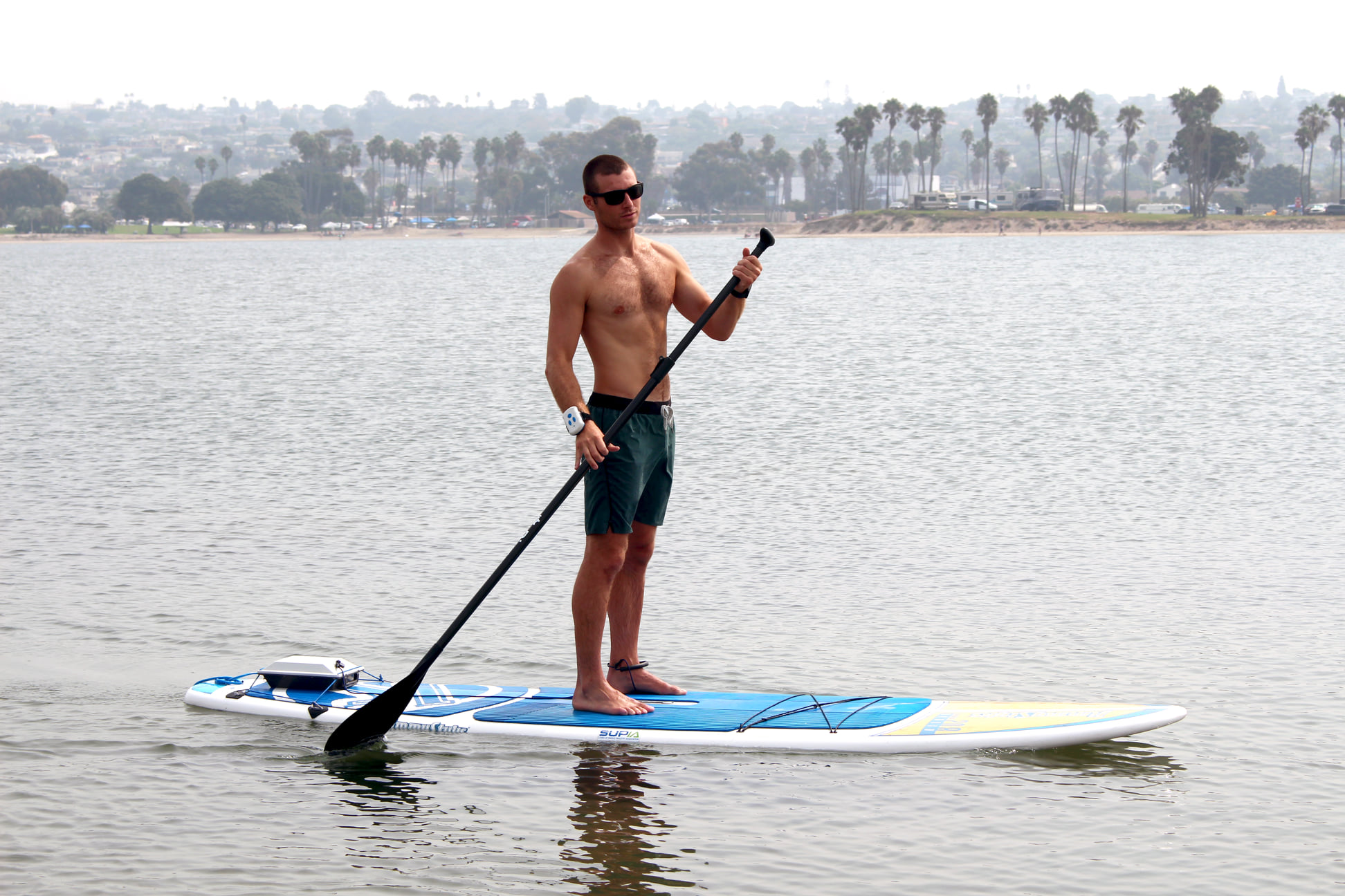 man paddleboarding with Bixpy motors