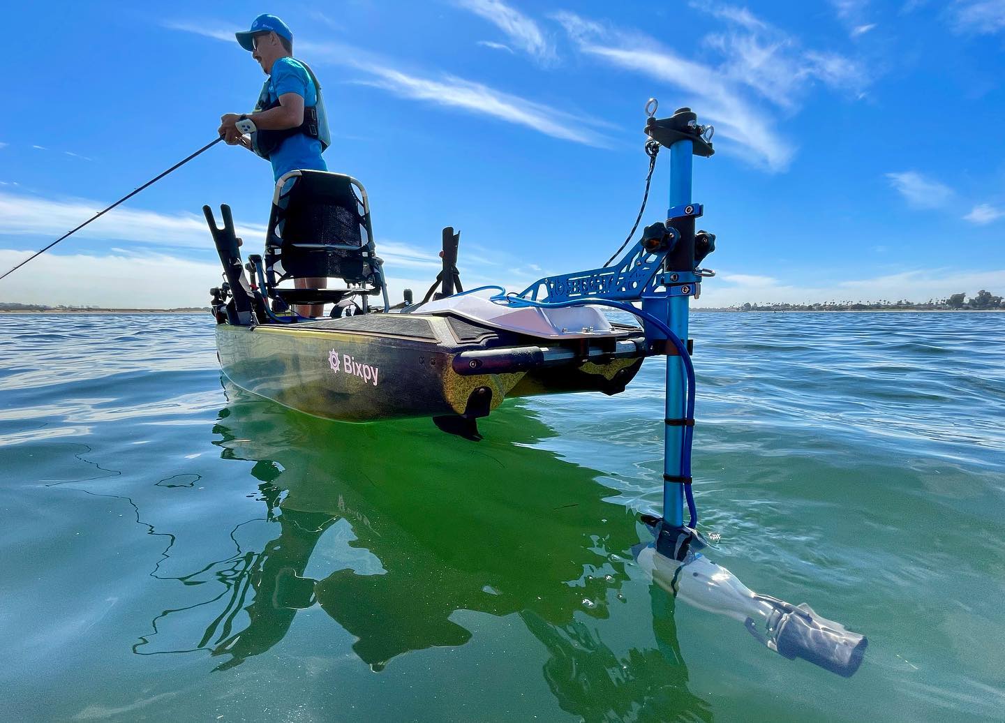 Man fishing from kayak with Bixpy power pole and Bixpy motor