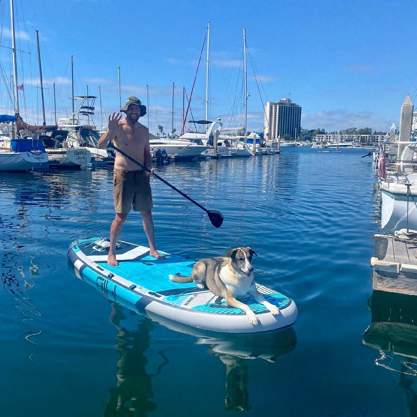 Man with dog on SUP with Bixpy motor
