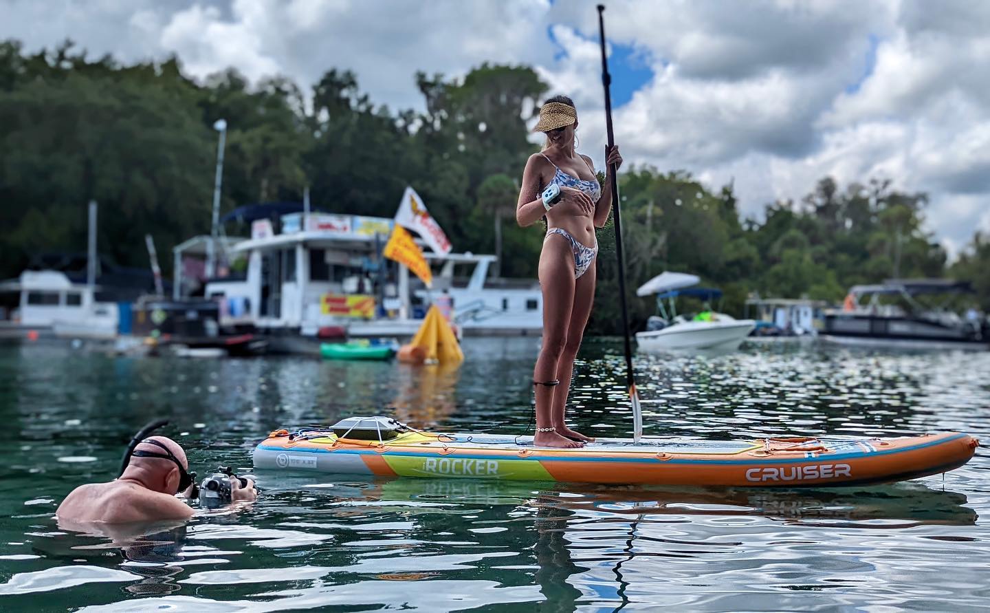 man takes photo of woman on paddleboard with Bixpy motor