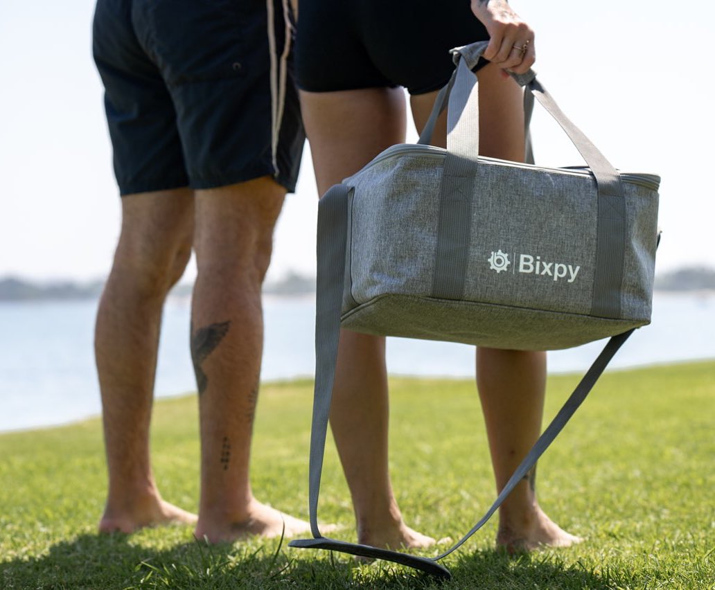 Man and woman carrying Bixpy travel bag