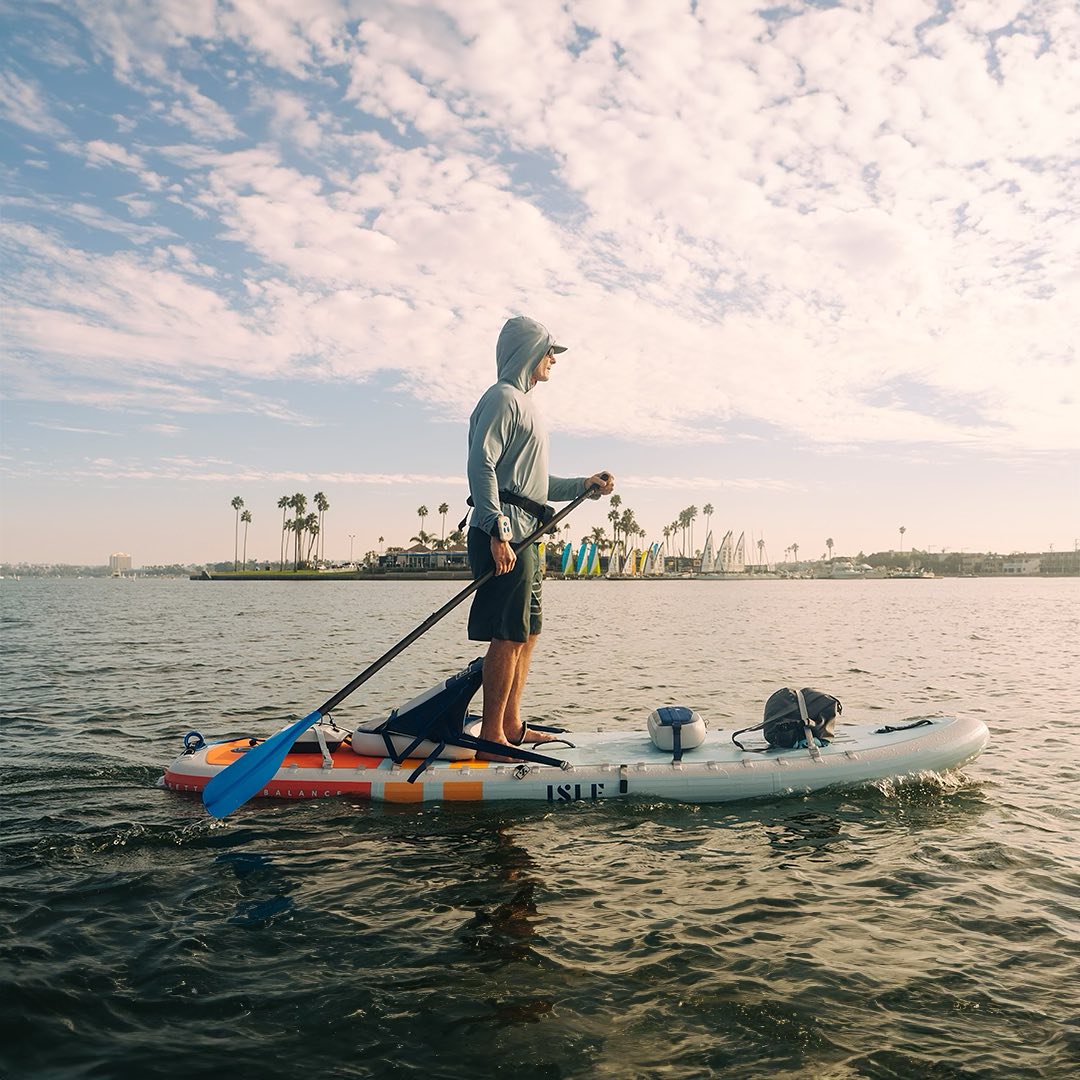 Man standing on paddleboard powered by a Bixpy motor