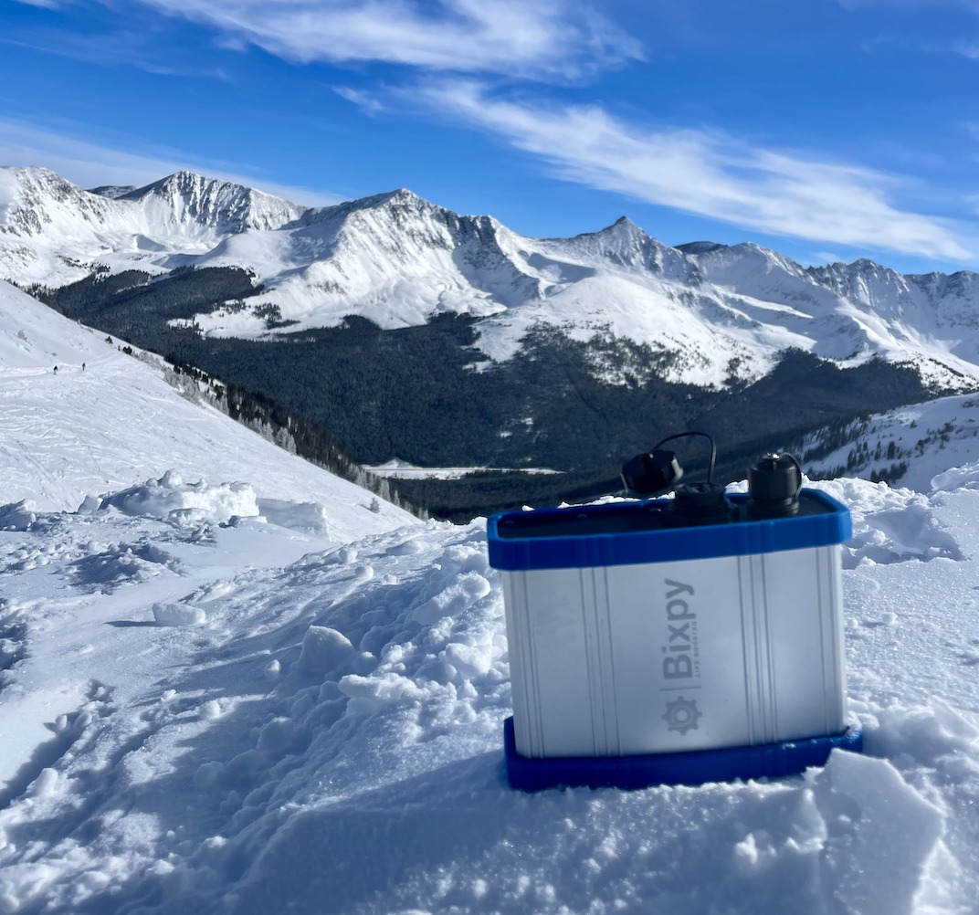 Bixpy Power Bank sitting atop a snow mountain