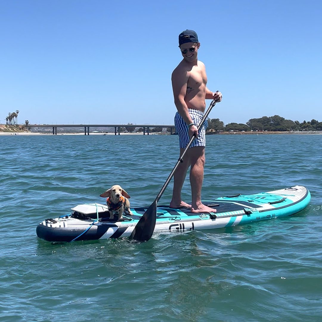 Man on SUP with dog, SUP powered by electric motor