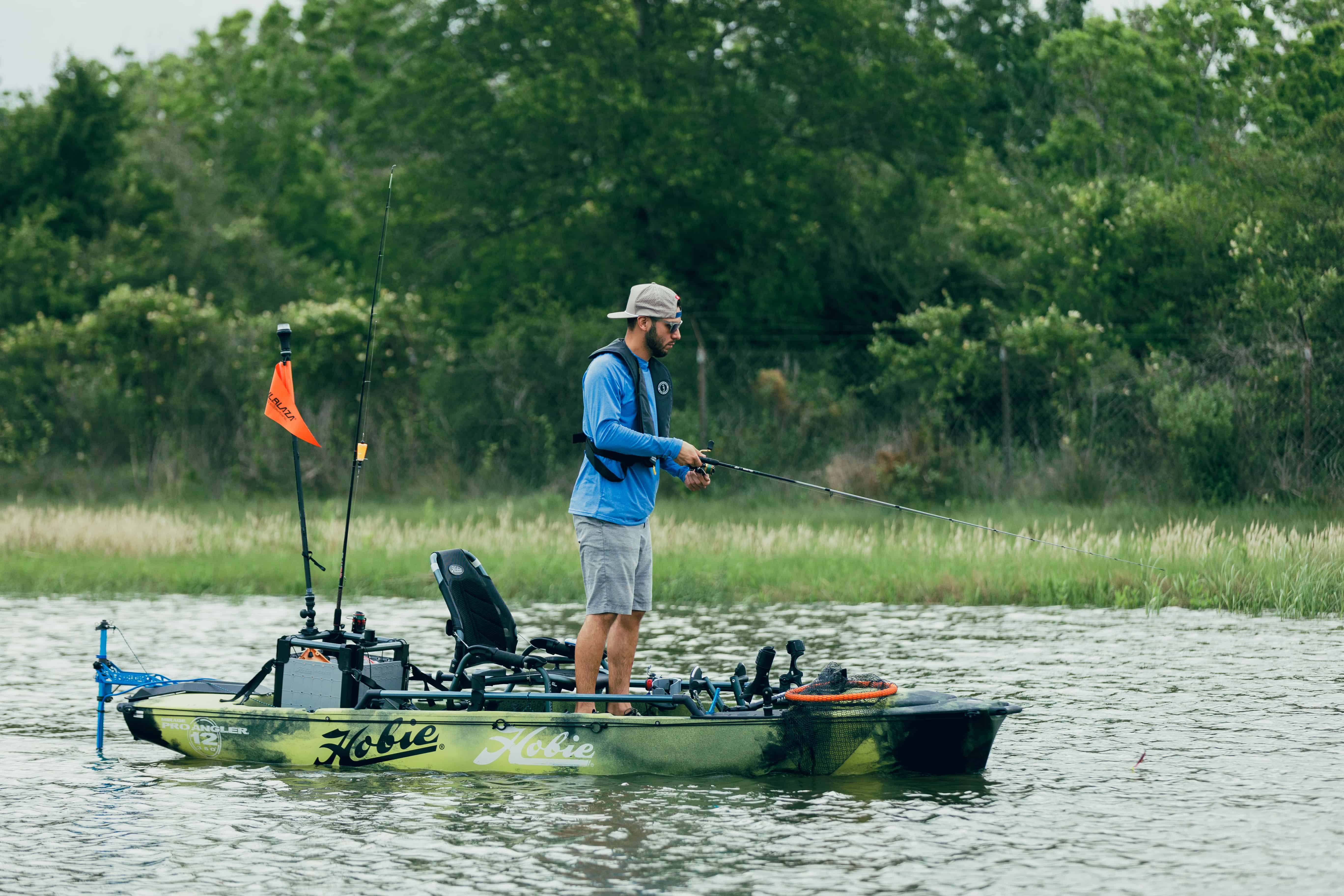 Man fishing from hobie kayak with Bixpy motor attached using a DIY adapter kit