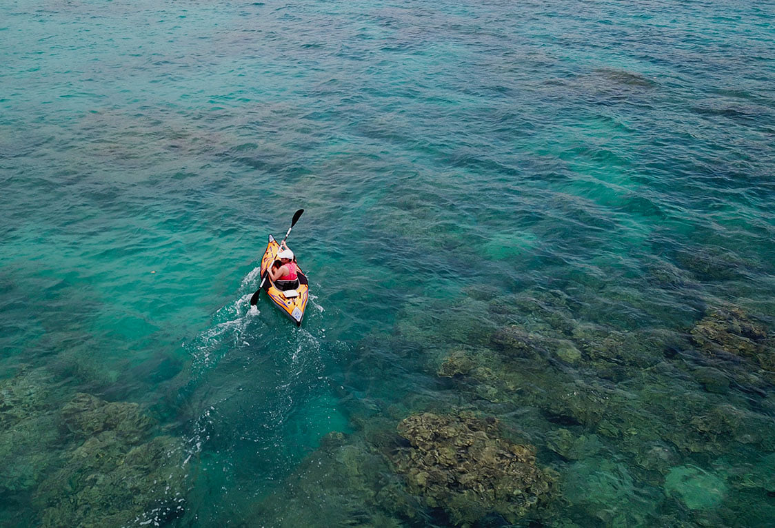 Kayak with Bixpy motor in clear blue water