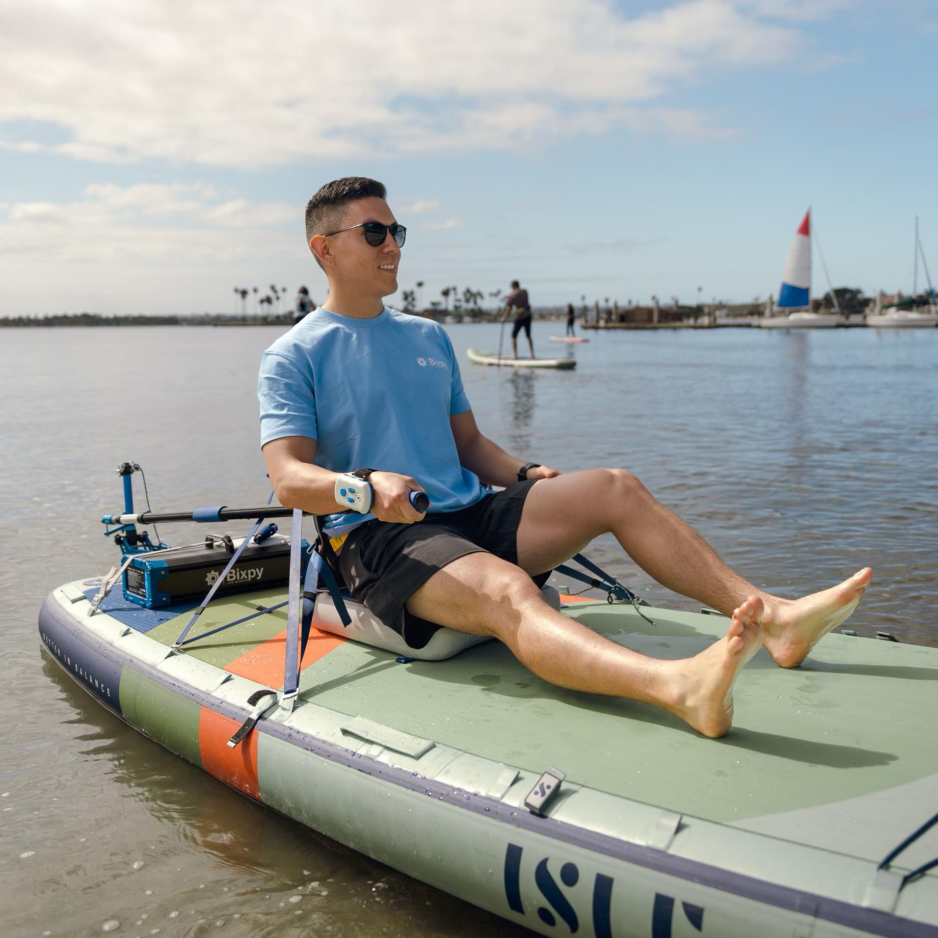 Man powers inflatable paddleboard with Bixpy motor